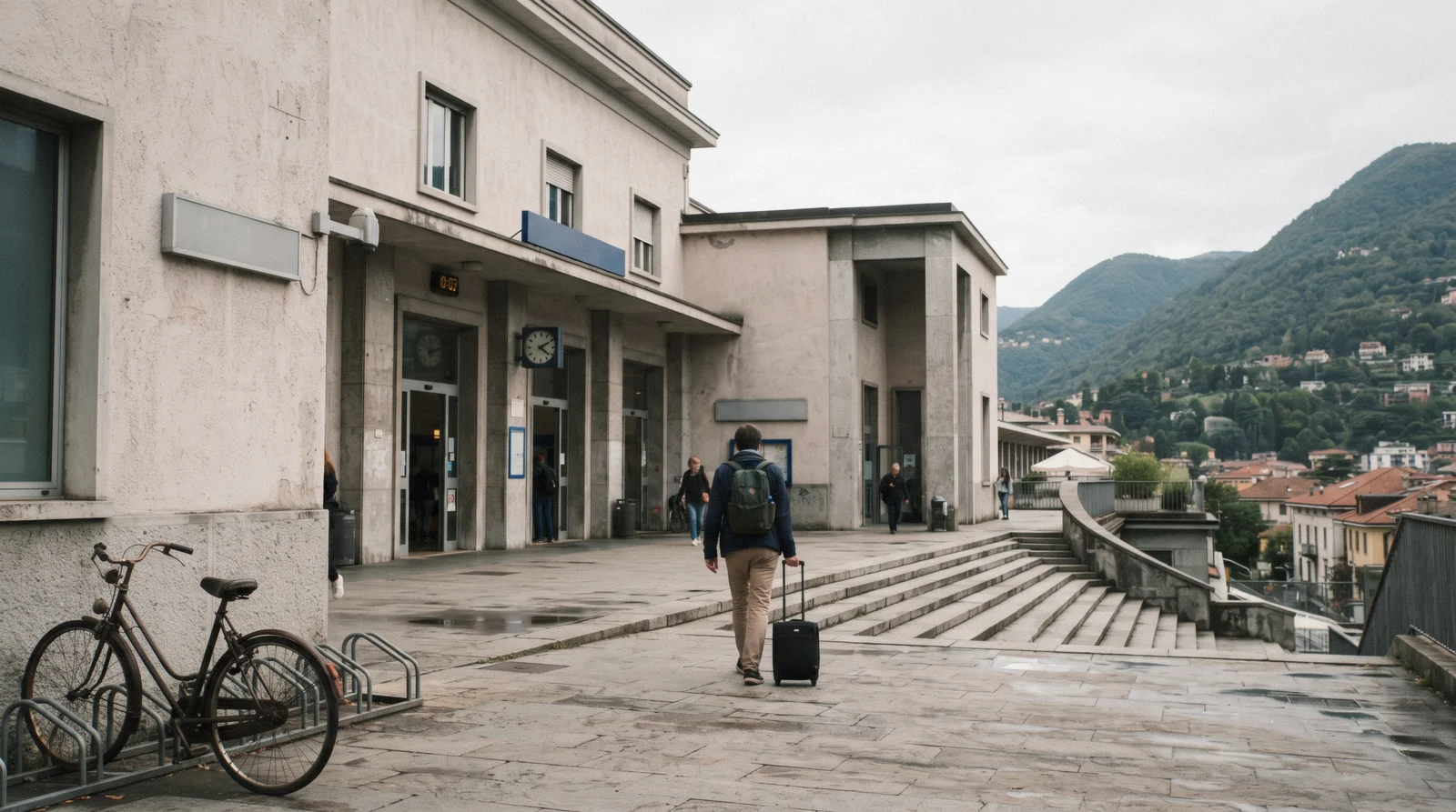 A traveller pulling a suitcase across the forecourt of Como San Giovanni station, the first stop when looking for Como luggage storage