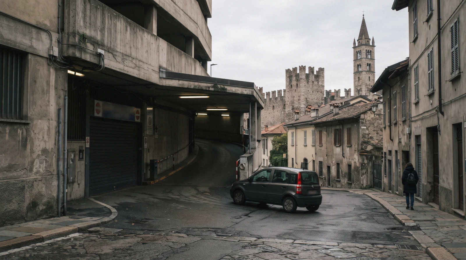 A multi-storey car park entrance on a street near Como old town in the morning, Como parking