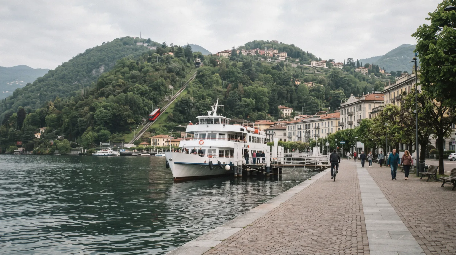 The lakefront by Piazza Cavour with the funicular on the green slope toward Brunate and a ferry at the pier, the three ways of getting around Como