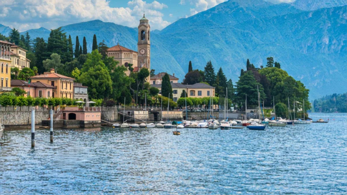A cruise boat crossing the lake toward the Swiss shoreline on a Lugano and Bellagio day tour from Como, Italy