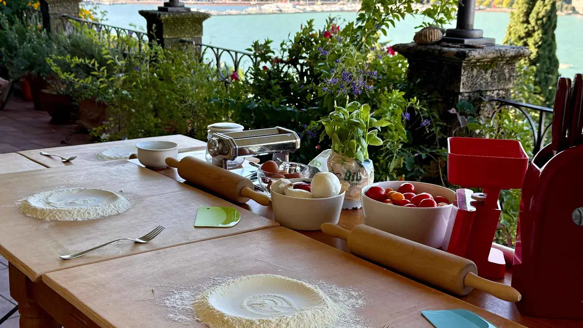 A pasta-making station on a terrace overlooking Lake Como on a cooking class in Como, Italy