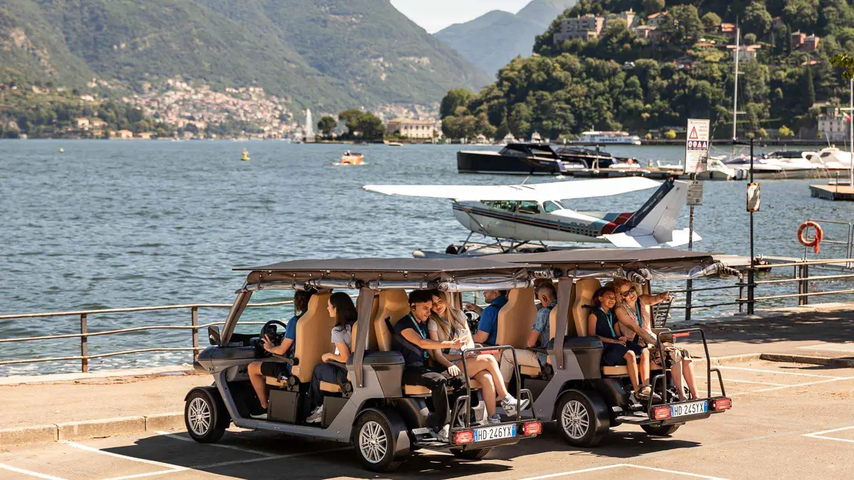 A golf cart parked along Como's lakefront promenade on a Como golf-cart city tour in Como, Italy